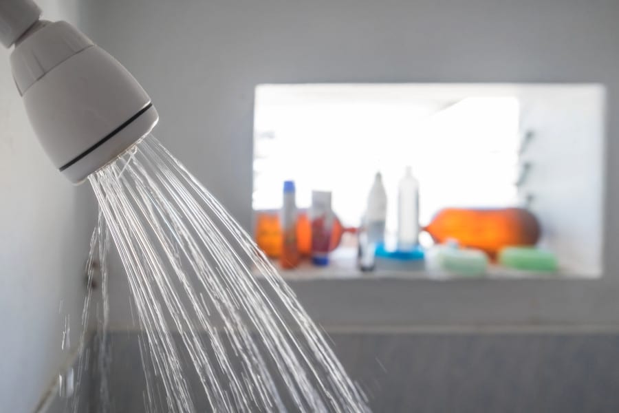 Why You Shouldn’t Take Hot Showers, According to Dermatologists